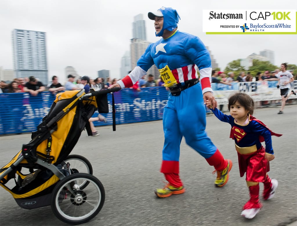 Felipe Vega and his daughter, Guilina, 2, approach the finish line of the 2013 Statesman Capitol 10,000 race on Sun., April 7, 2013. Ashley Landis for American-Statesman